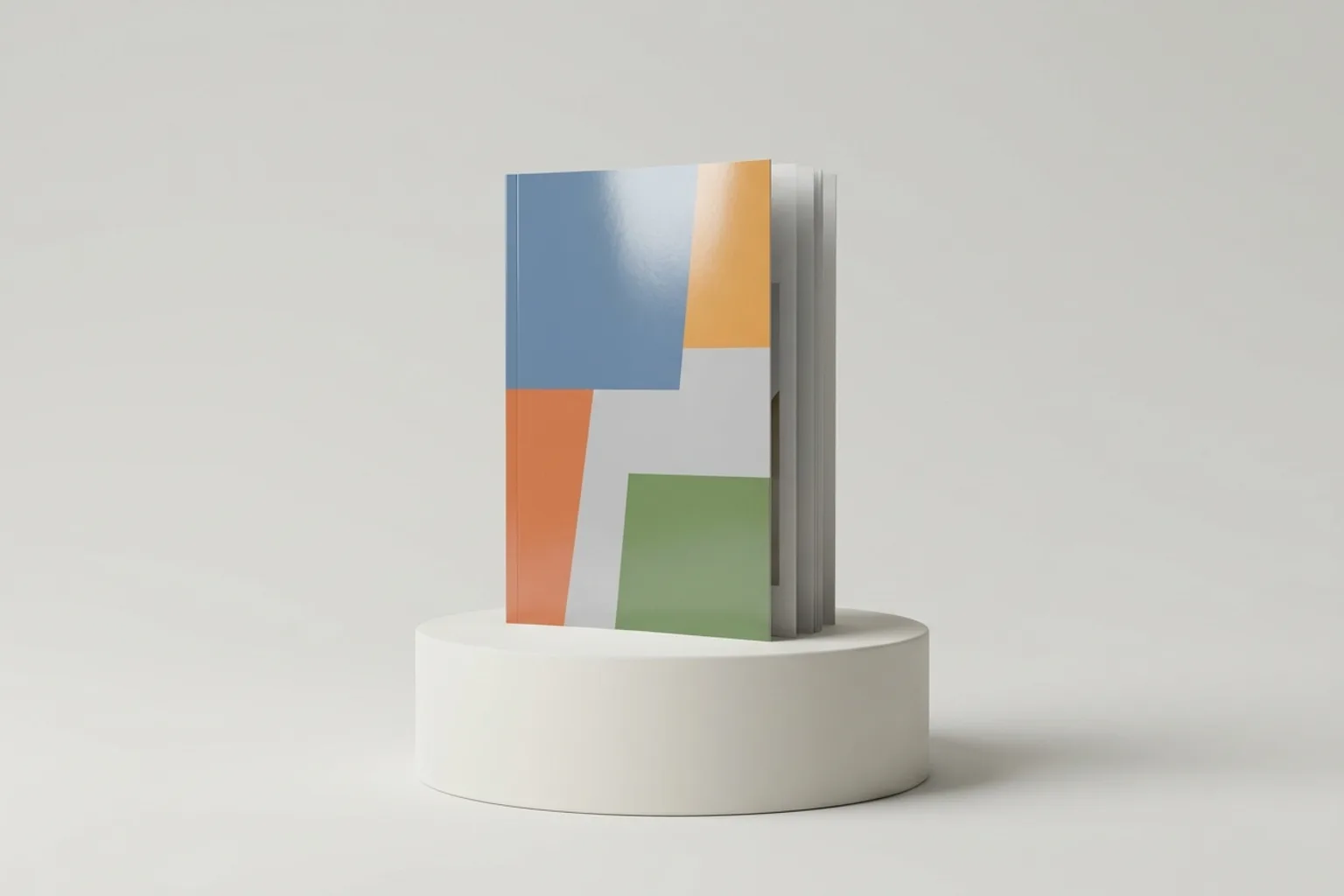 Magazine A4 dressé et entrouvert sur un socle clair, couverture en aplats de couleur